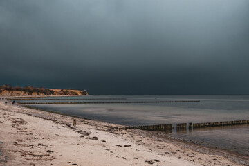 The cliffs of Boltenhagen on the Baltic Sea and the sky is very dark