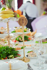 Beautiful table setting for wedding celebration in restaurant. Empty glasses and white napkins are installed in the restaurant on the table. Part of the interior. Elegant table set