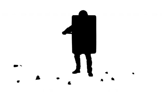 Silhouette Trash is thrown into special unit policeman with the shield up.