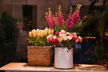 A bouquet of spring flowers, tulips of different colors on a shop window. Flower shop on the street of Italy.