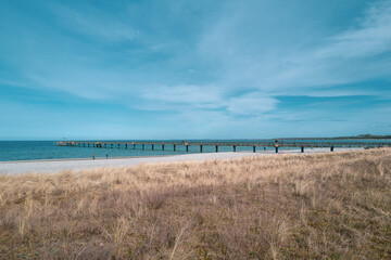 a beach and the blue water of the Baltic Sea and the sky is blue