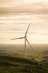 wind turbines at cloudy sunset