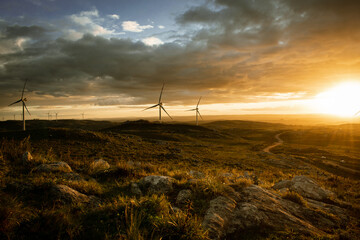 wind turbines at cloudy sunset