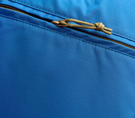 open zipper of a pocket in a blue backpack
