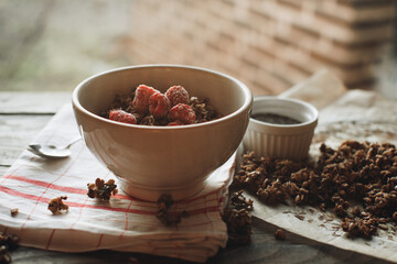Delicious and healthy breakfast with raspberries. Morning aesthetics and beautiful layout on a wooden table. Granola for healthy breakfast.