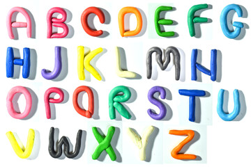 Colored English letters made of plasticine. Alphabet isolated on white background. Flat lay. copy the space.