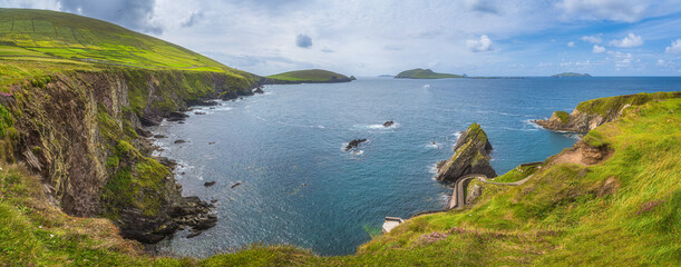 Beautiful panoramic shot of amazing Dunquin Pier and harbour with tall cliffs, turquoise water and islands, Dingle, Wild Atlantic Way, Kerry, Ireland