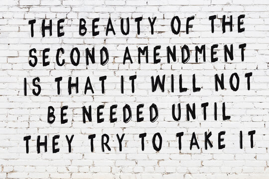 White brick wall with painted black inscription of wise quote