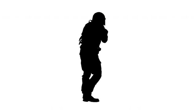 Silhouette Police special forces officer holding position.
