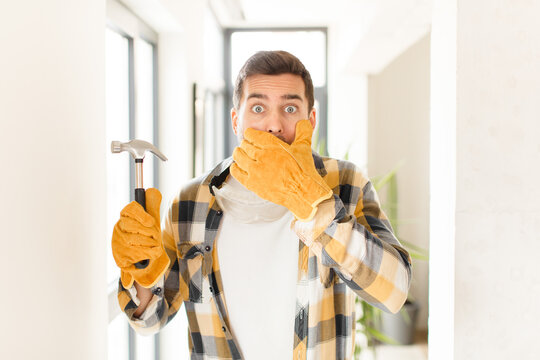 handyman covering mouth with hands with a shocked, surprised expression, keeping a secret or saying oops