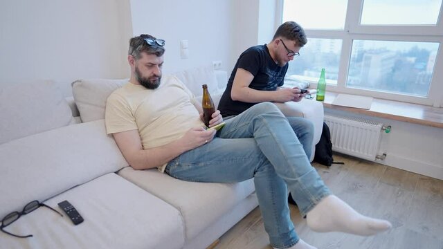 A modern home meeting where everyone is looking at their phones. Youth communication problems and smartphone addiction nomophobia