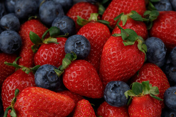 Strawberries with blueberries, top view. Close up background.