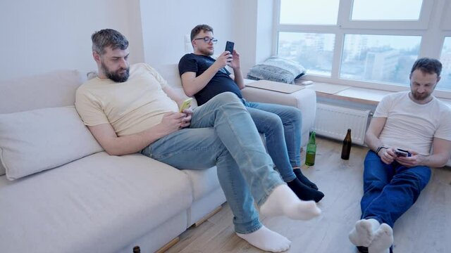 A modern home meeting where everyone is looking at their phones. Youth communication problems and smartphone addiction nomophobia