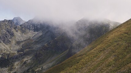 Koscielec from Kasprowy Wierch. Mountain covered in the clouds. High quality photo - obrazy, fototapety, plakaty