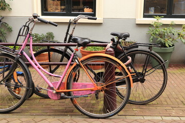 Fototapeta na wymiar Pink and Orange Painted Bicycle in Amsterdam, Holland