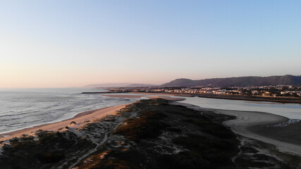 DRONE AERIAL FOOTAGE: Northern Litoral Natural Park in Ofir, Fao, Esposende, Portugal at sunset. The two sides of Restinga de Ofir. One facing the ocean, the other the estuary of Cávado River.