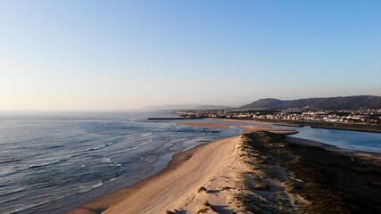 Aerial view of the Northern Litoral Natural Park in Ofir, Fao, Esposende, Portugal at sunset. The two sides of Restinga de Ofir. One facing the ocean, the other the estuary of Cávado River.