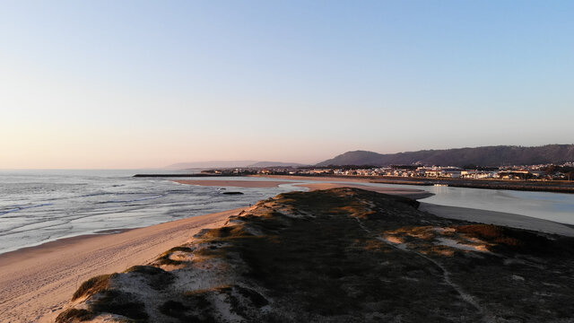 Aerial view of the Northern Litoral Natural Park in Ofir, Fao, Esposende, Portugal at sunset. The two sides of Restinga de Ofir. One facing the ocean, the other the estuary of C&aacute;vado River.