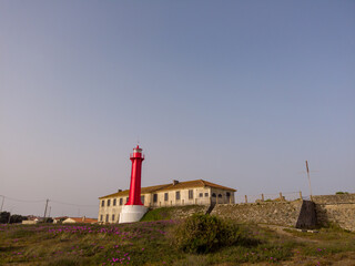 Fototapeta na wymiar The Farol de Esposende (Esposende Lighthouse) set in front of the Fort of Sao Joao Baptista de Esposende is situated at the mouth of Cavado river, north of Portugal.