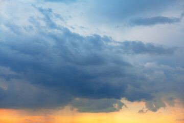 Blue clouds with slight rain in the evening light
