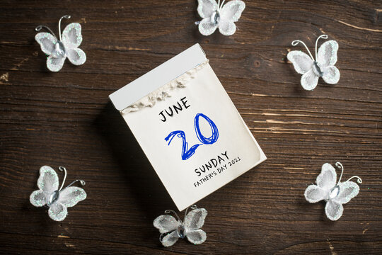 tear-off calendar showing JUNE 20 SUNDAY FATHER'S DAY 2021 on wooden background