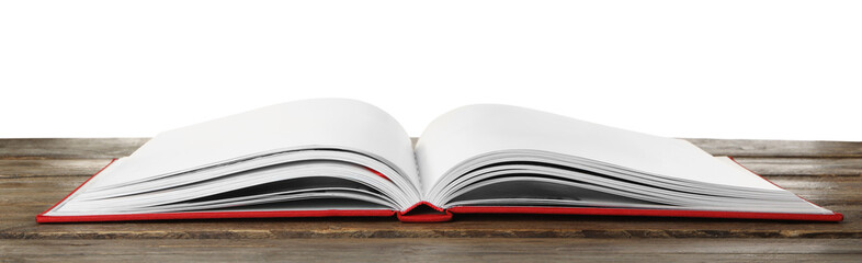 Open book with red cover on wooden table against white background