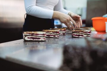 A professional confectioner makes and decorates delicious cakes.