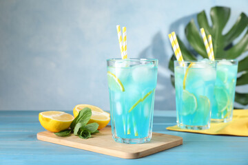 Delicious refreshing cocktail with ice on wooden table