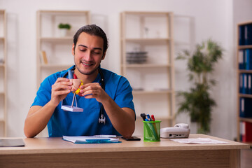 Young male doctor cardiologist working in the clinic