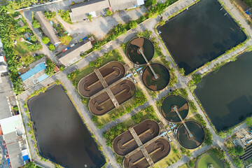 Aerial view High angle view Top down drone shot of the sewage treatment plant.The Solid contact clarifier tank type sludge recirculation in water treatment plant. Industrial wastewater treatment plant
