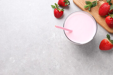 Delicious strawberry drink on light grey table, flat lay. Space for text