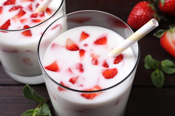 Delicious drink with strawberries on table, closeup
