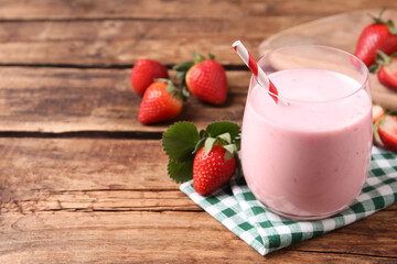 Delicious drink with strawberries on wooden table, space for text