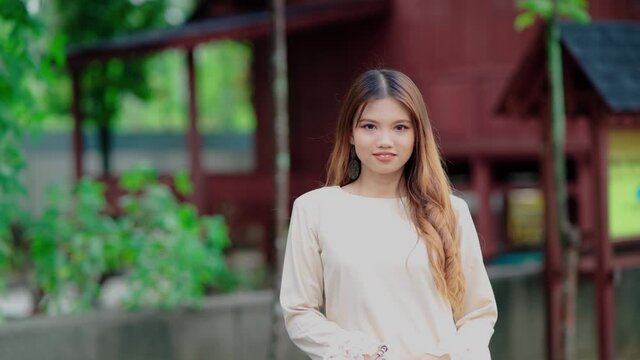 beautiful malay girl with malay house in the background