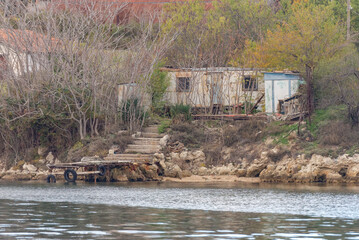 Fototapeta na wymiar Private house with its own marina. House on the sea from improvised materials in the Streletskaya Bay of Sevastopol.