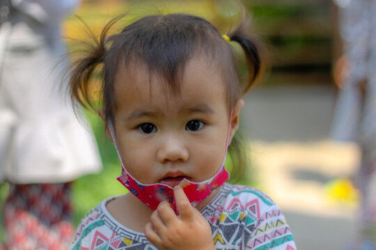 child Portrait, Cute Asian child girl with hijab looking camera medium shot blurred background with copy spece and text, outdoor daylight, concept little girl Muslim lifestyle preschool 3-5 years old,