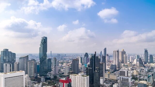 Bangkok business district city center above Silom area, with cloud pass over buildings and skyscrapers; zoom in – Time Lapse