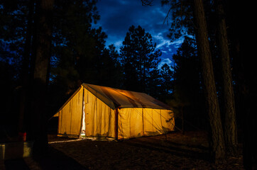 Camping tent illuminated from within at night