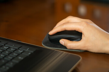 Close up to hand clicking on mouse