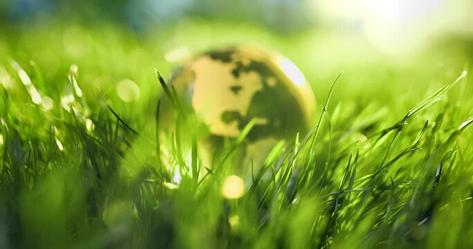 Close up of crystal globe resting on grass,environment concept
