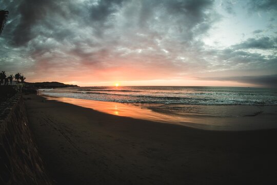 horizontal shot from the beach to the sea watching the sunset © Paredes Luis