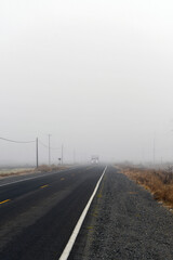 vertical shot of an empty road during fog