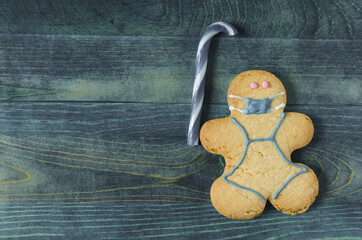 masked cookie man figurine on blue background sweet dessert masked man figurine kopi space