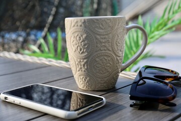 laptop and cup in the table