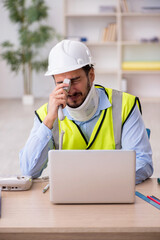 Young neck injured male architect in safety concept