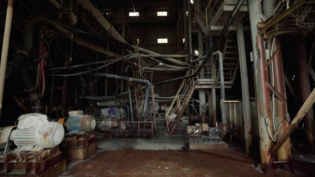 Engine steam power machine in old factory. Abandoned hangar of old rusty industrial metallurgical factory, atmosphere of destruction and post-apocalypse