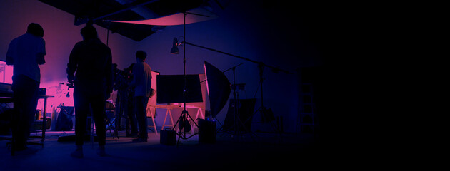 Neon Blue pink color shooting. behind the scene of video production set up in the big studio. Crew...