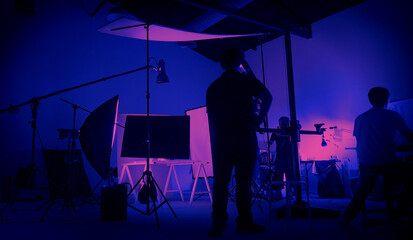 Neon Blue pink color shooting. behind the scene of video production set up in the big studio. Crew...