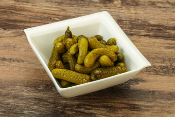 Pickled gherkin in the bowl