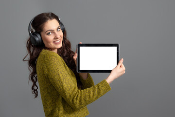 emotional, attractive young woman showing tablet computer with empty touch screen with copy space